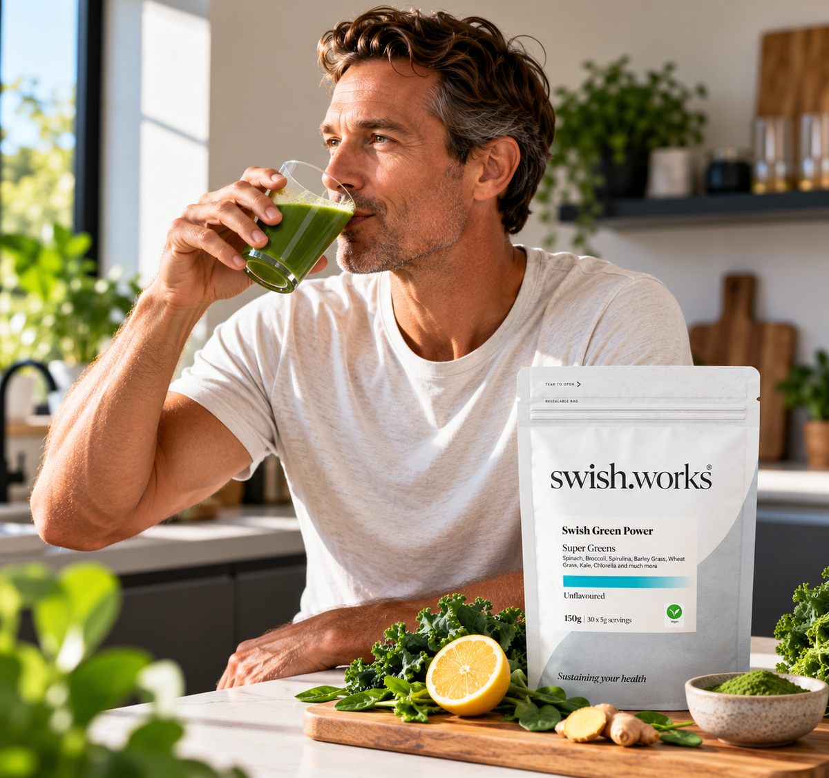 A man drinking a glass of swish.works Green Power super greens